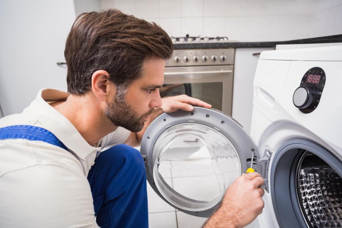 handyman doing washer dryer repair